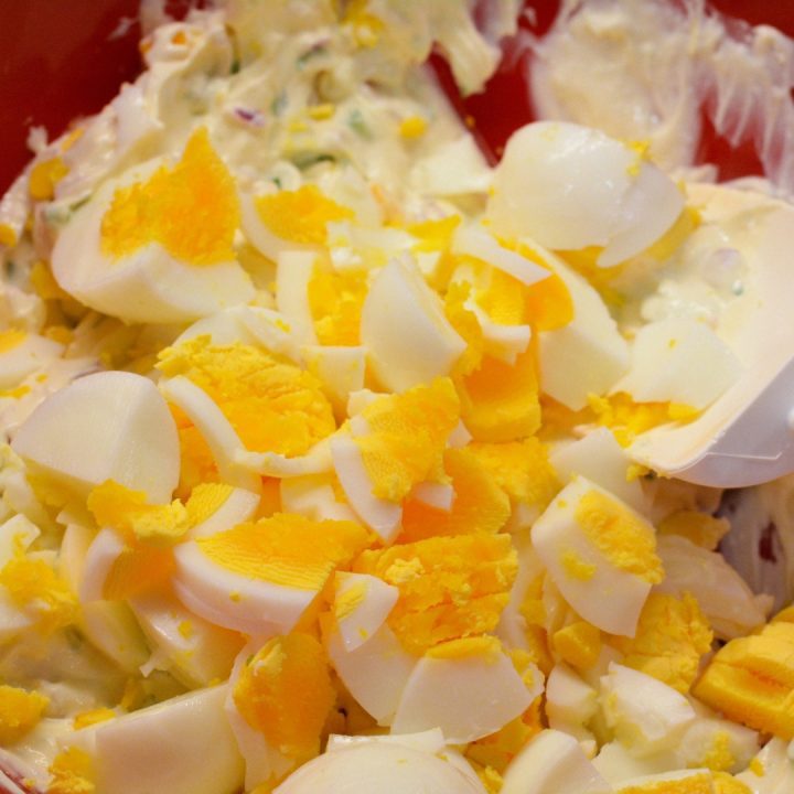 Next, add the chopped eggs. You can use an egg slicer for neat, even pieces. You can also finely chop the hard-boiled eggs on a cutting board. and you have a creamy egg salad. Adjust the mayo, mustard, and seasonings to your taste.