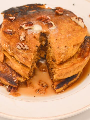 Pumpkin spice pancakes have real canned pumpkin in the batter and are easy to make with a store-bought pancake mix.