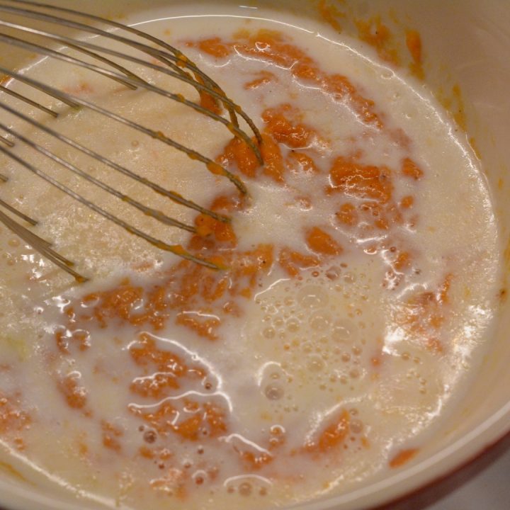 in a separate bowl, beat the egg. Stir in the milk, melted butter, and pumpkin puree.