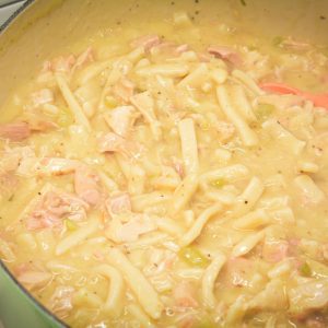 Turkey and Noodles made with leftover turkey is easily made on the stove by sauteing onoins, celery, and garlic together before adding the turkey, broth, and Reames wide noodles.