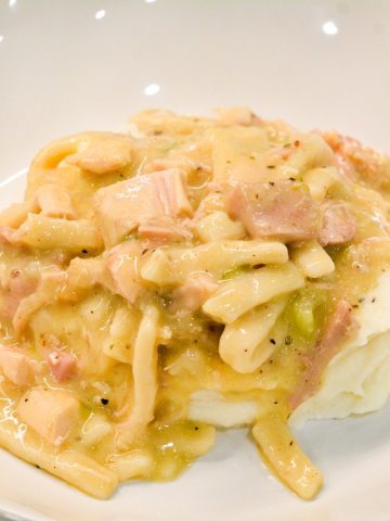 Turkey and Noodles made with leftover turkey is easily made on the stove by sauteing onoins, celery, and garlic together before adding the turkey, broth, and Reames wide noodles.