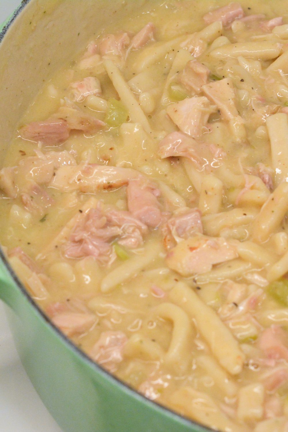 Turkey and Noodles made with leftover turkey is easily made on the stove by sauteing onoins, celery, and garlic together before adding the turkey, broth, and Reames wide noodles.
