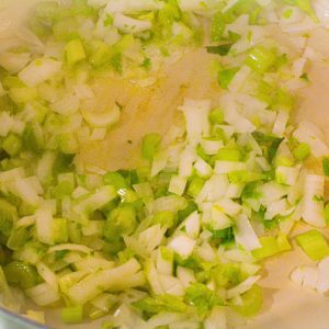 Put the diced onions, celery, and garlic into the Dutch oven along with butter. Sauté until the onions just begin to soften.