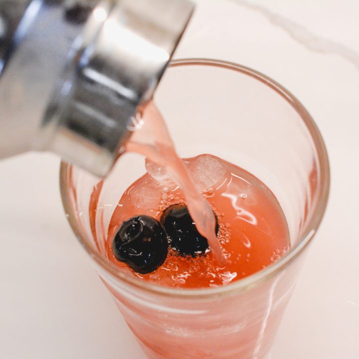 Pour the orange and cranberry cocktail base into cocktail glasses or champagne flutes. Then top each glass or flute with chilled prosecco or champagne.