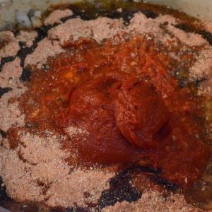 Add tomato paste, spaghetti sauce, zesty spaghetti packet. Stir to combine and then add the better than bouillon and balsamic vinegar to the Dutch Oven.
