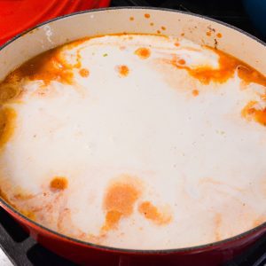 Add water to the pan until the spaghetti is just covered. Then pour in the alfredo sauce.