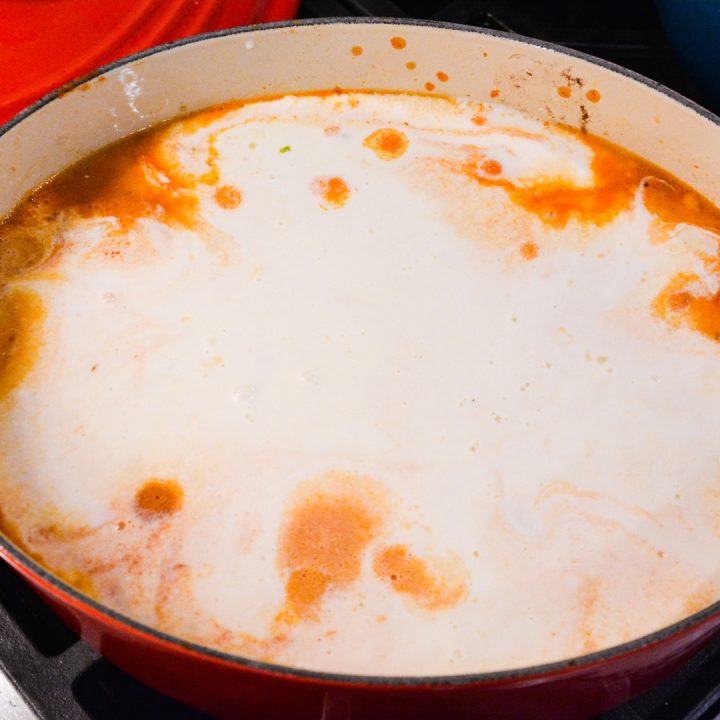 Add water to the pan until the spaghetti is just covered. Then pour in the alfredo sauce.