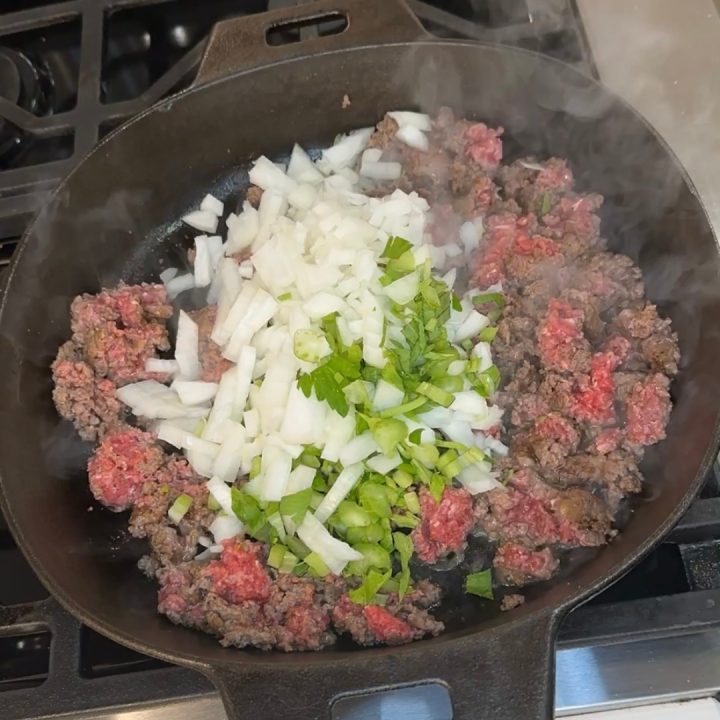 In a skillet over medium heat, brown the ground beef until fully cooked. Before the beef is fully cooked add the onions, celery, and gourmet burger seasoning.