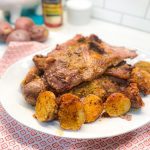 Crispy parmesan potatoes and pork steak are an easy sheet pan meal can be prepped ahead of time and baked for an easy weeknight dinner.