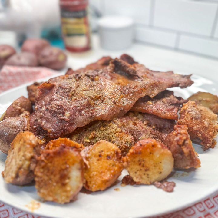 Crispy parmesan crusted potatoes and pork steak are an easy sheet pan meal that can be prepped ahead of time and stored in the fridge or freezer until meal time.