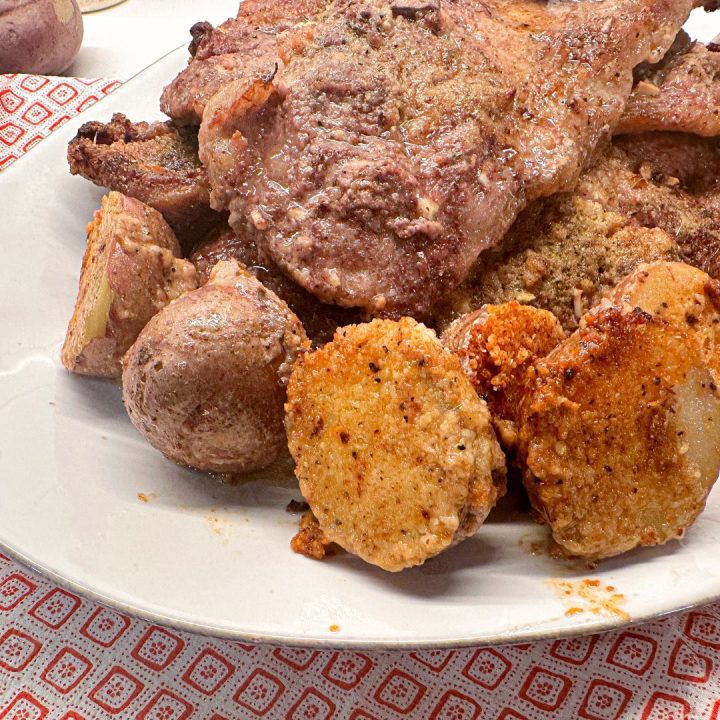 Crispy parmesan crusted potatoes and pork steak are an easy sheet pan meal that can be prepped ahead of time and stored in the fridge or freezer until meal time.