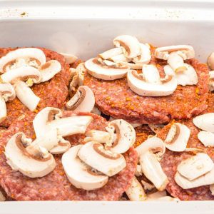 Season the remaining patties and lay over the top of the first layer of patties and mushrooms.