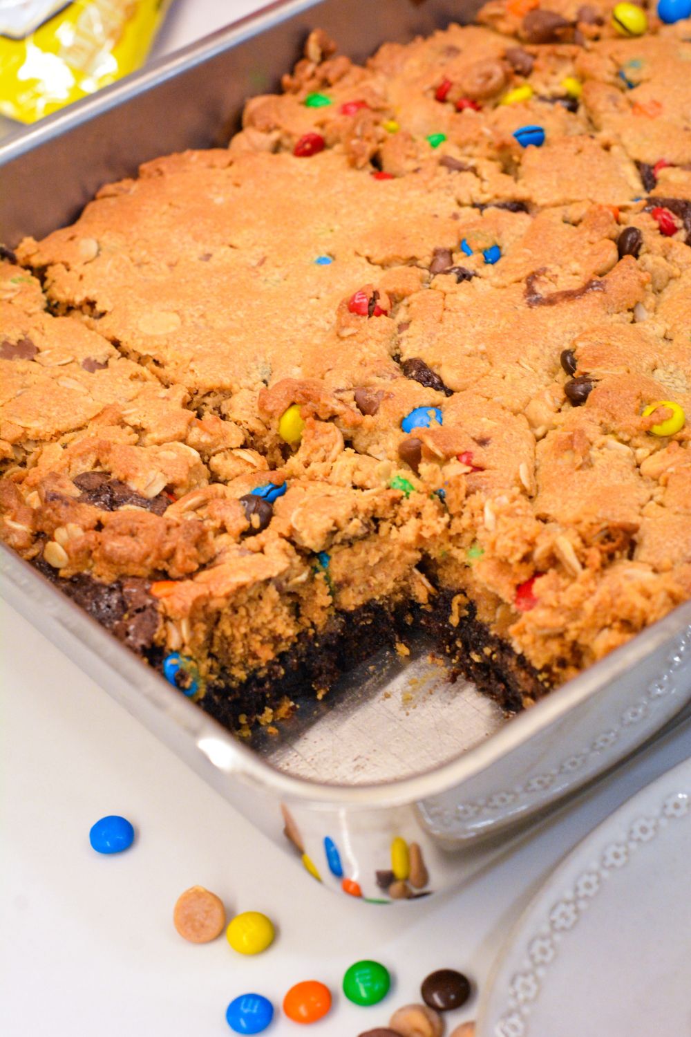 Fudgy brownies monster cookie bars combine a brownie mix with a peanut butter cookie dough mix with the addition of oatmeal, peanut butter, chocolate chips, m&m's and peanut butter chips.