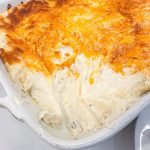 Mashed potato casserole is made with potatoes, cream cheese, sour cream, and French fry seasoning and topped off with shredded cheddar cheese make the ultimate party potatoes.