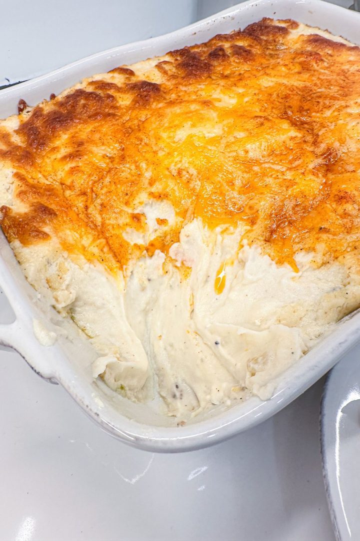 Mashed potato casserole is made with potatoes, cream cheese, sour cream, and French fry seasoning and topped off with shredded cheddar cheese make the ultimate party potatoes.