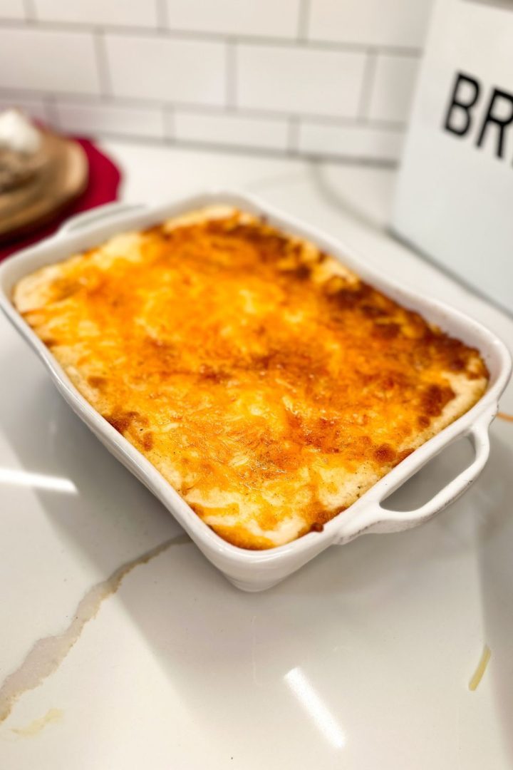 Mashed potato casserole is made with potatoes, cream cheese, sour cream, and French fry seasoning and topped off with shredded cheddar cheese make the ultimate party potatoes.