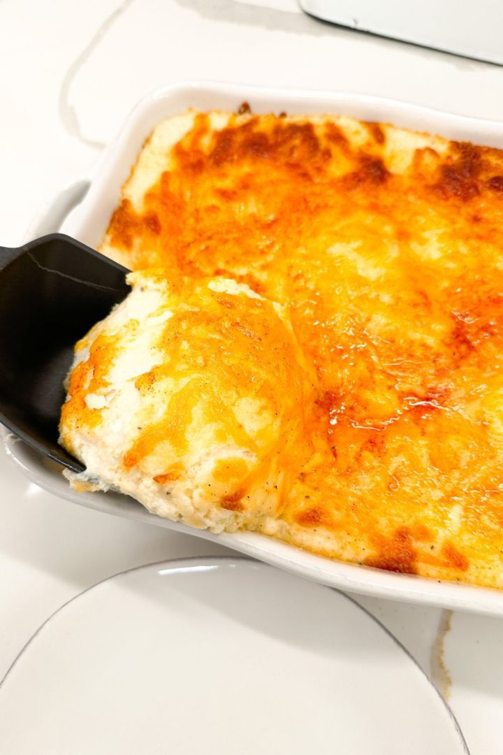 Mashed potato casserole is made with potatoes, cream cheese, sour cream, and French fry seasoning and topped off with shredded cheddar cheese make the ultimate party potatoes.