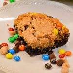 These fudgy brownie monster cookie bars will be a major hit and one off your favorite brookie bar recipes.