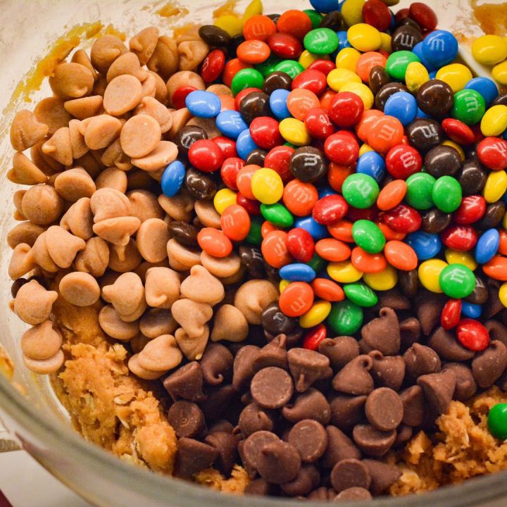 In a separate bowl, prepare the peanut butter cookie mix as directed on the package. Mix in the oatmeal, peanut butter, chocolate and peanut butter chips, and candies to make the monster cookie dough.