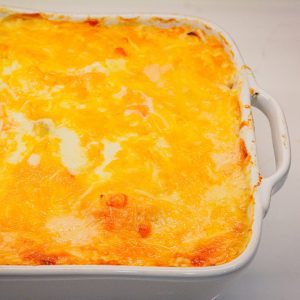 This cheese scalloped potatoes recipe uses both yellow potatoes and sweet potatoes along with onions, white sauce, and lots of cheese to make the ultimate cheesy au gratin potatoes.