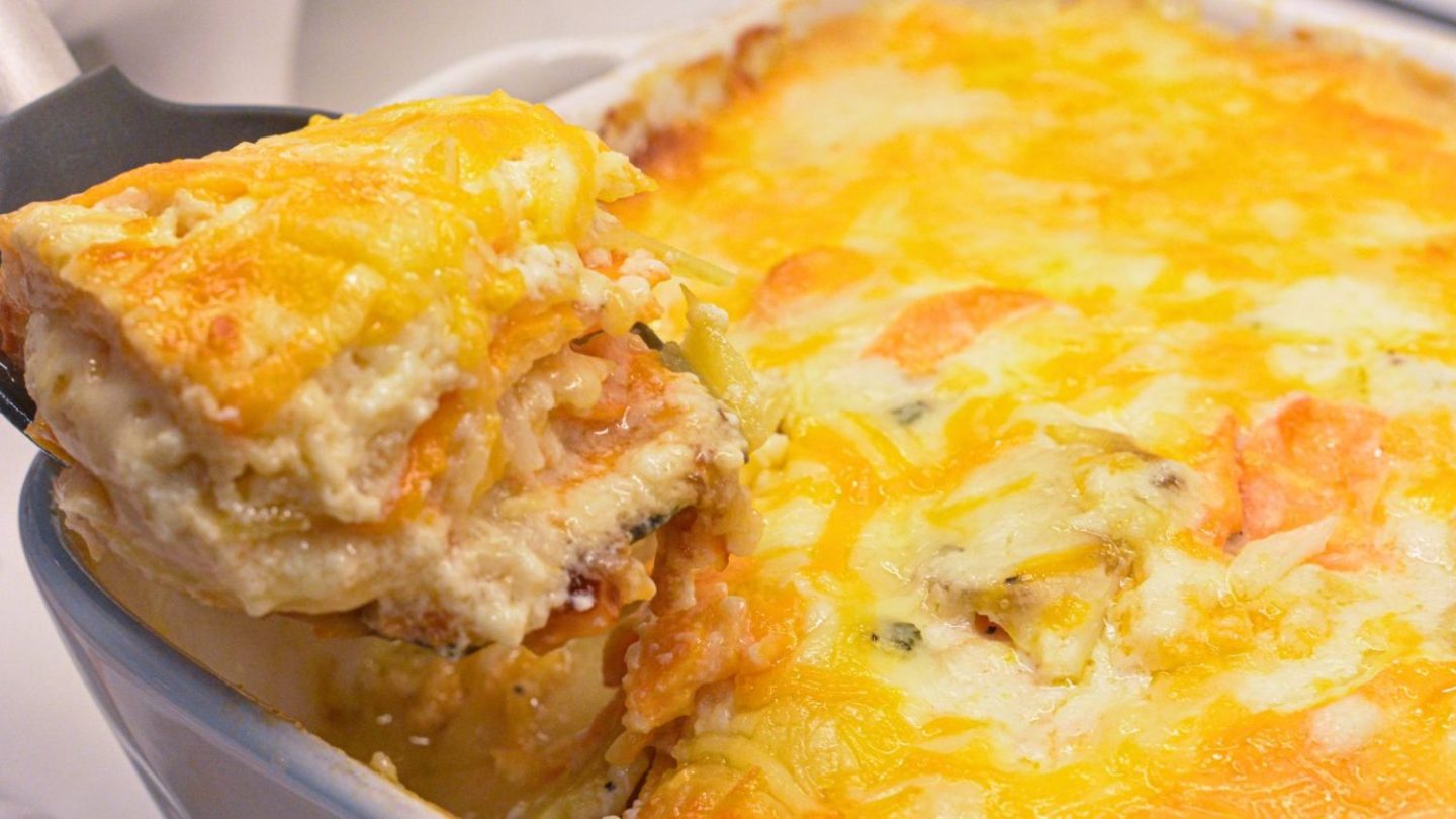 This cheese scalloped potatoes recipe uses both yellow potatoes and sweet potatoes along with onions, white sauce, and lots of cheese to make the ultimate cheesy au gratin potatoes.