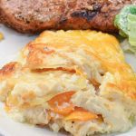 This cheese scalloped potatoes recipe uses both yellow potatoes and sweet potatoes along with onions, white sauce, and lots of cheese to make the ultimate cheesy au gratin potatoes.