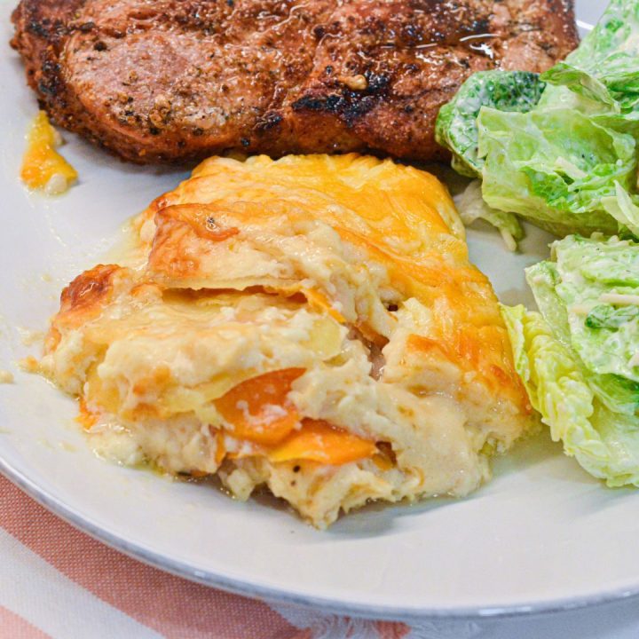 This cheese scalloped potatoes recipe uses both yellow potatoes and sweet potatoes along with onions, white sauce, and lots of cheese to make the ultimate cheesy au gratin potatoes.