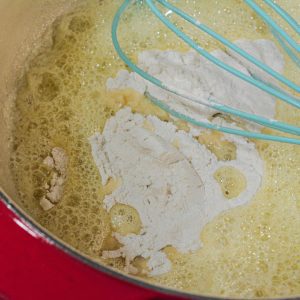 Butter, garlic, and flour making a roux for white sauce for scalloped potatoes.