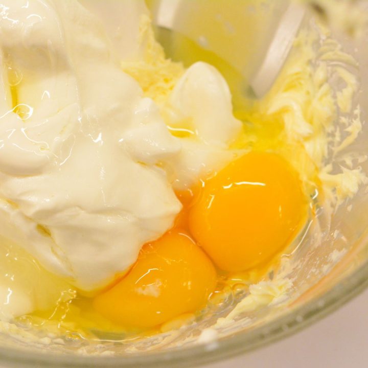 Then add the sour cream, eggs, and vanilla to the creamed butter. Mix to get thoroughly mixed together, and there is no visibility of egg yolks.
