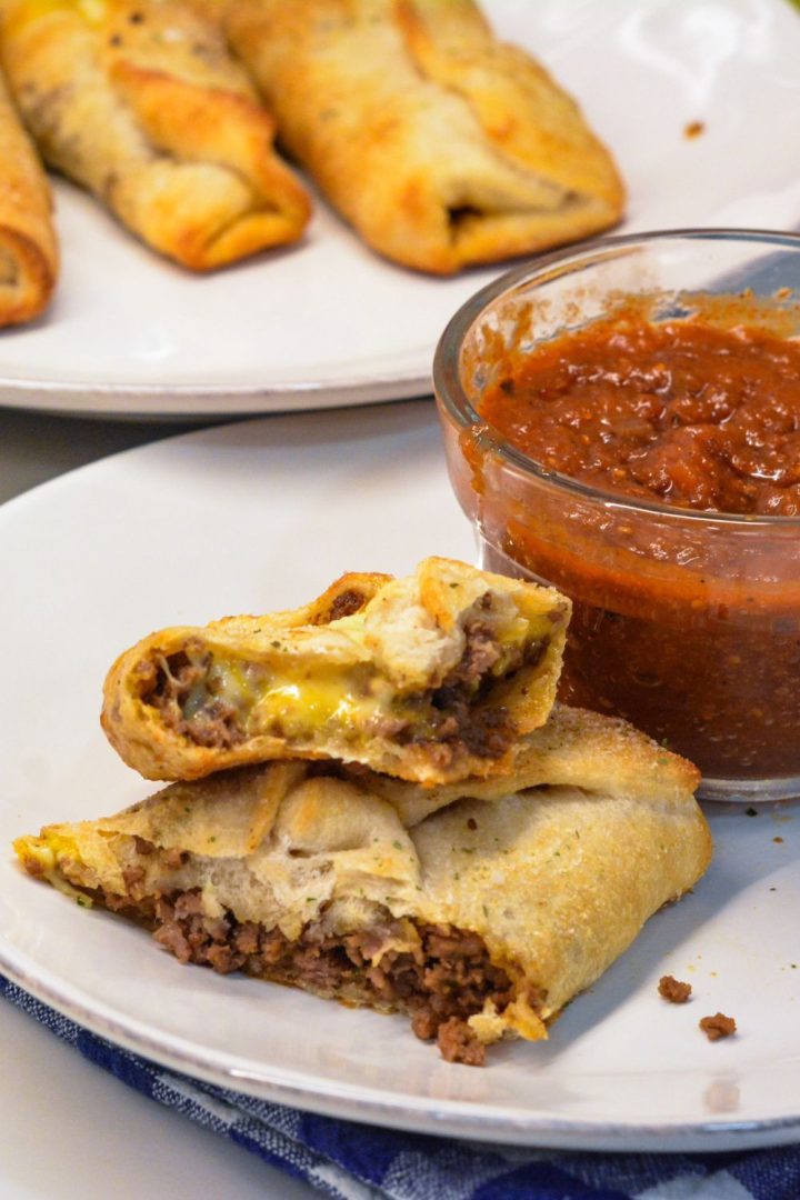 Taco sticks are made by wrapping taco meat and a colby-jack cheese stick in pizza dough then baking for 10 minutes for an easy weeknight meal recipe.