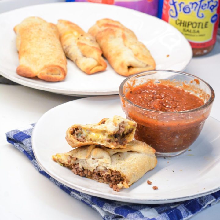 Taco sticks are made by wrapping taco meat and a colby-jack cheese stick in pizza dough then baking for 10 minutes for an easy weeknight meal recipe.