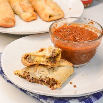 Taco sticks are made by wrapping taco meat and a colby-jack cheese stick in pizza dough then baking for 10 minutes for an easy weeknight meal recipe.