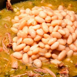 Pour the pureed green sauce and white beans over the pork. Season with salt and black pepper to your taste, stir to combine and cook on low for an additional hour.