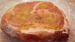 Rub oil and adobo seasoning on the pork shoulder(s). Place the pork shoulder on the smoker. Flip after 30 minutes