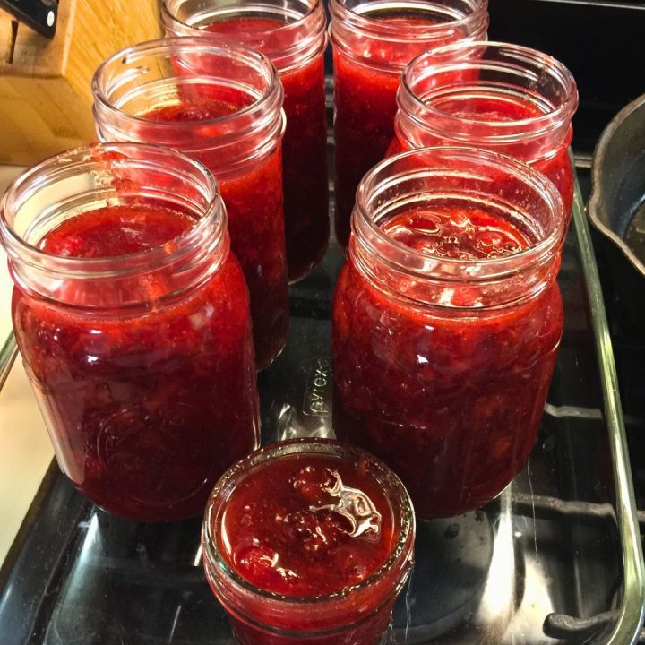 Then, ladle the jam into clean, sterilized mason jars, leaving a ½-inch space at the top to expand during freezing. You can use pint or half pint jars. Seal the jars tightly with lids.