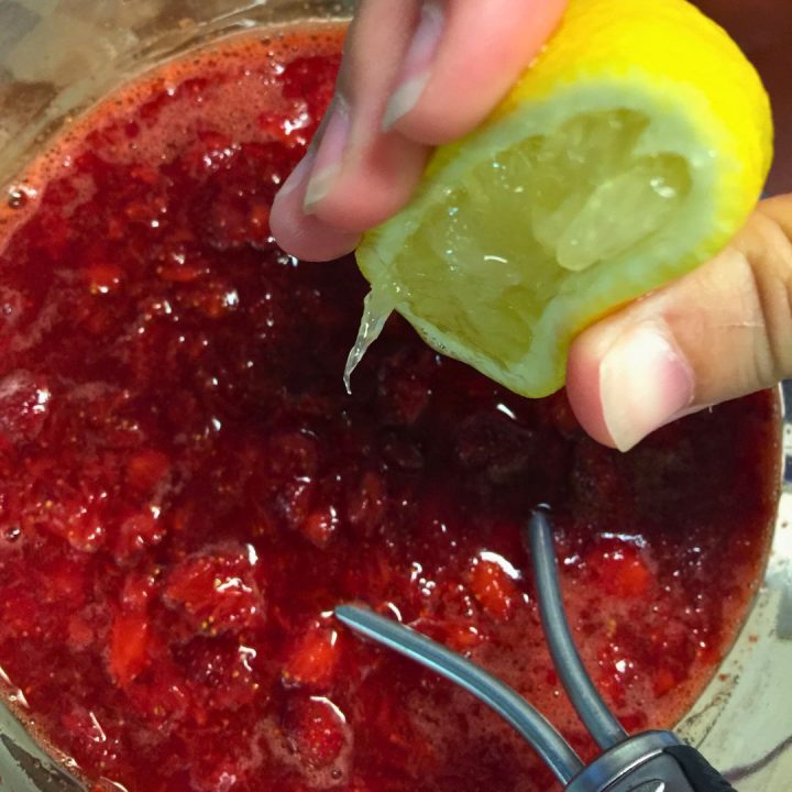 Pour the boiling water and pectin over the crushed strawberries. Next, pour the lemon juice over the strawberries. Stir in the fresh lemon juice and pectin. 