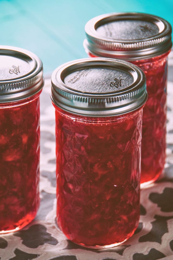You can create a jar of homemade strawberry freezer jam that's bursting with flavor with strawberries, pectin, sugar, lemon juice, and water.