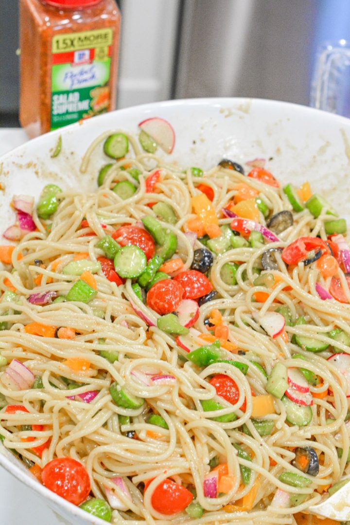 Cold Spaghetti Pasta Salad is a garden vegetable heaven in this delicious Italian pasta salad filled with cucumbers, celery, carrots, onions, peppers, olives, tomatoes, and parmesan cheese.