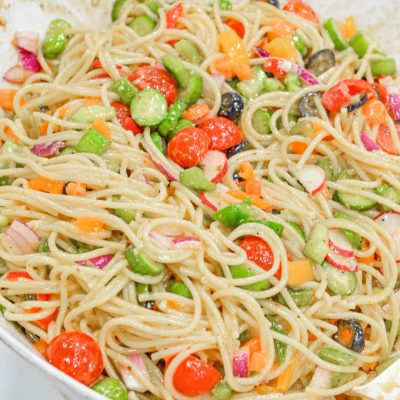 Cold Spaghetti Pasta Salad is a garden vegetable heaven in this delicious Italian pasta salad filled with cucumbers, celery, carrots, onions, peppers, olives, tomatoes, and parmesan cheese.