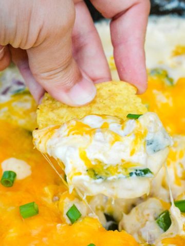 This smoked corn dip is made on your smoker or in your oven with ground pork, roasted poblanos, cream cheese, shredded cheddar cheese, and adobo seasoning.