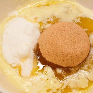 In a large mixing bowl, stir together the melted butter and melted Crisco. Add the brown sugar and granulated sugar, mixing until smooth. Then stir in the eggs and vanilla extract until well combined.