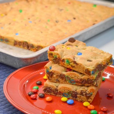 These M&M and Chocolate Chip Cookie Bars with Vanilla Pudding are soft, chewy, and loaded with chocolatey goodness! The secret? Melted butter + Crisco and a box of vanilla pudding mix for that perfect gooey texture.