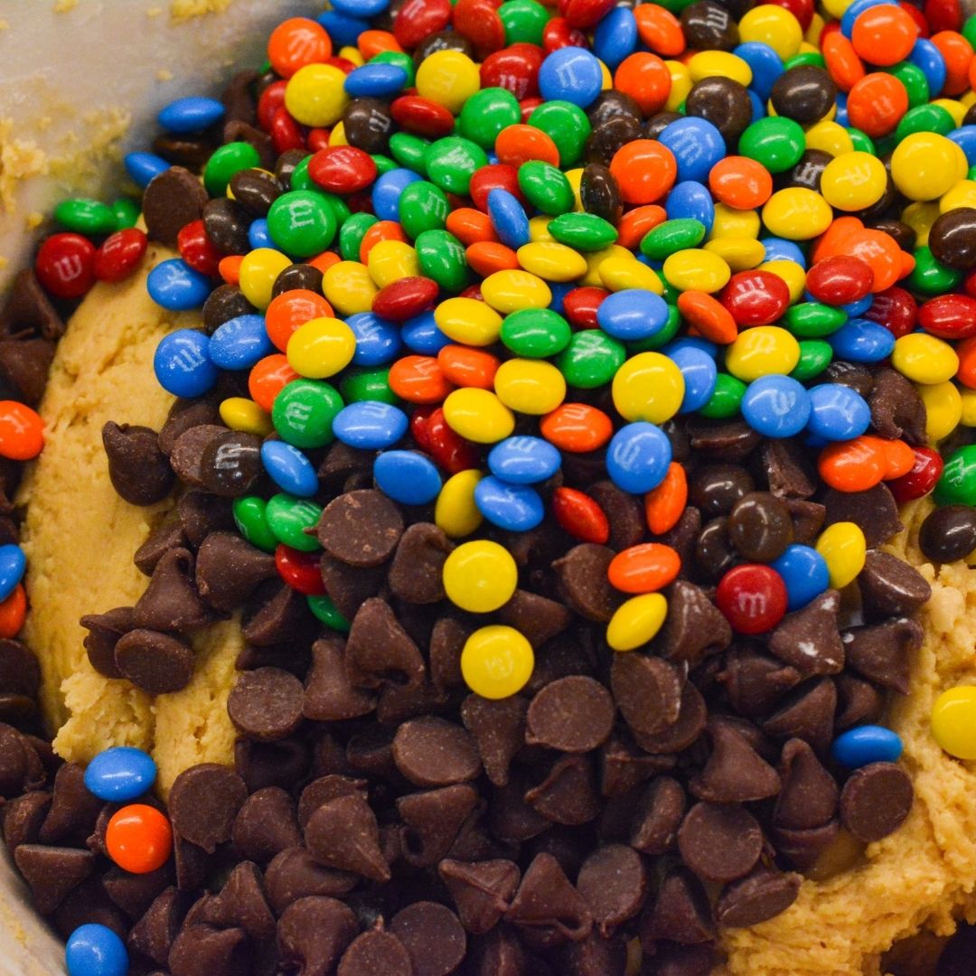 Gently fold in the mini chocolate chips and 1 cup of the mini M&M's, reserving the rest for topping.