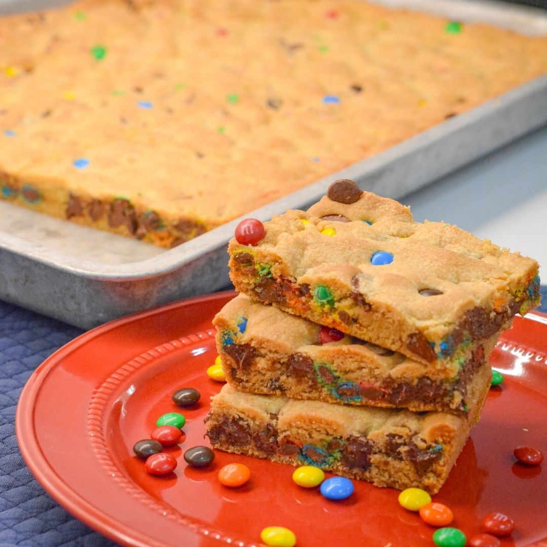 These M&M and Chocolate Chip Cookie Bars with Vanilla Pudding are soft, chewy, and loaded with chocolatey goodness! The secret? Melted butter + Crisco and a box of vanilla pudding mix for that perfect gooey texture.
