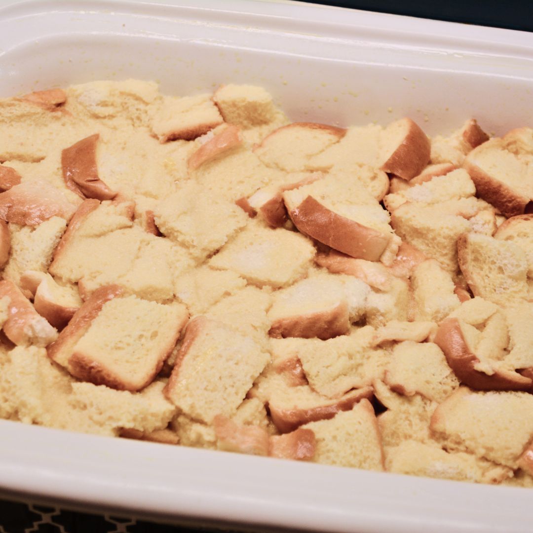 Evenly pour the egg mixture over the bread cubes. Press gently to make sure all bread is soaked. Drizzle melted butter on top. Refrigerate overnight.