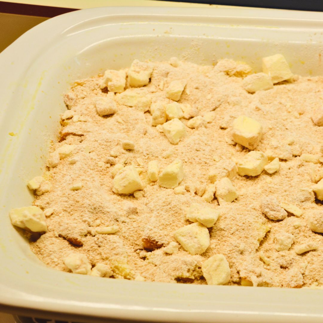 In the morning, make the crumb topping. Combine the flour, brown sugar, cinnamon, salt, and cold butter, cut into small pieces. Pour over the top of the bread.