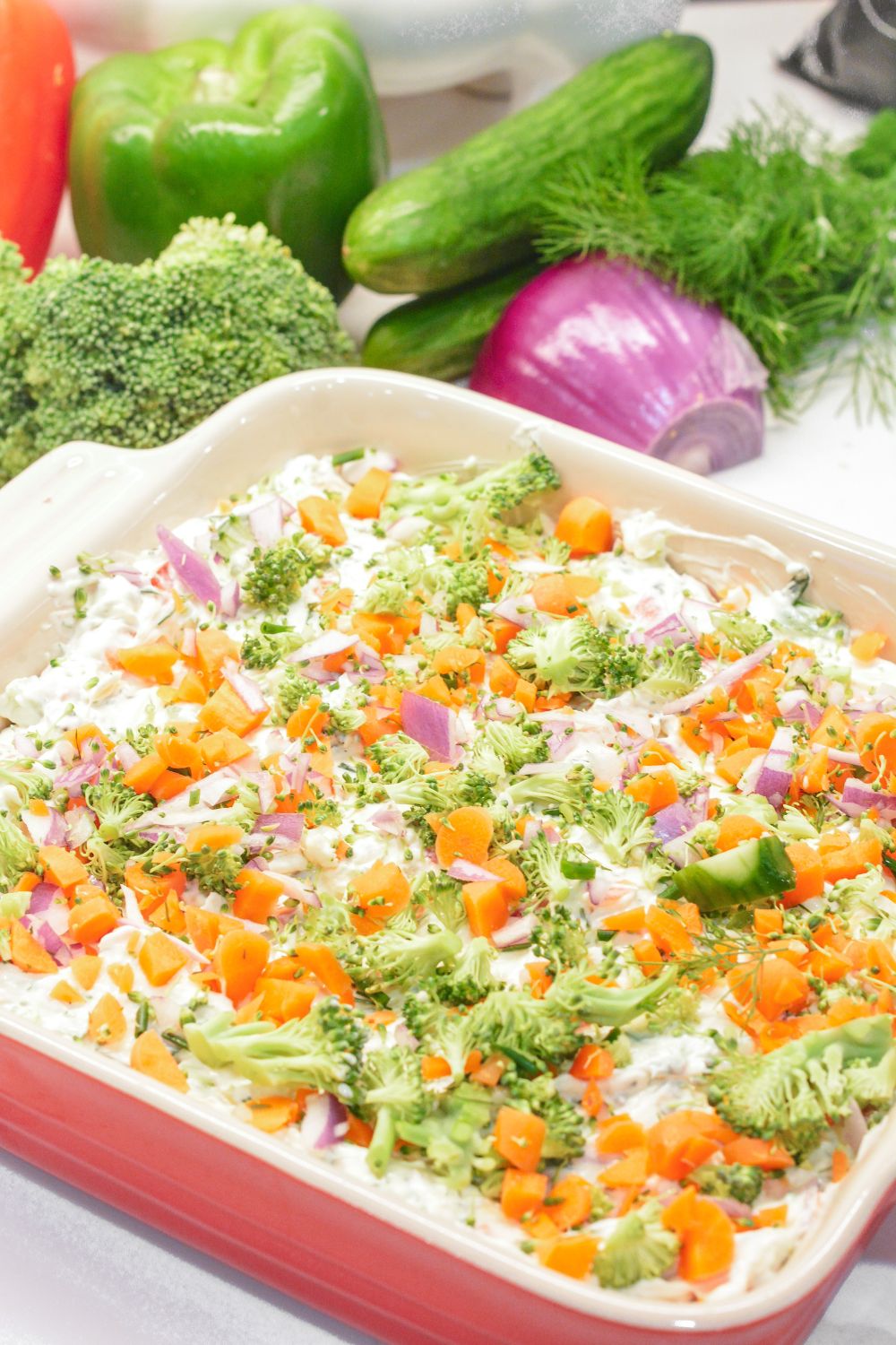 This easy veggie pizza dip is a creamy, no-bake appetizer made with cream cheese, ranch, cheddar cheese, and fresh chopped veggies. Perfect for parties, potlucks, and game day!