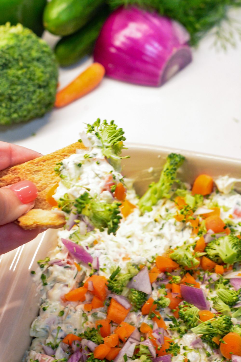 This easy veggie pizza dip is a creamy, no-bake appetizer made with cream cheese, ranch, cheddar cheese, and fresh chopped veggies. Perfect for parties, potlucks, and game day!