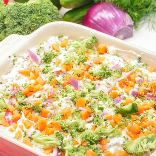 This easy veggie pizza dip is a no-bake party favorite loaded with cream cheese, ranch, herbs, cheddar cheese, and tons of chopped fresh veggies!