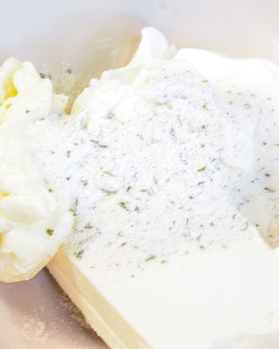 In a medium bowl, beat the softened cream cheese until smooth. Mix in the sour cream, ranch dressing, dill, and chives until well combined and creamy.